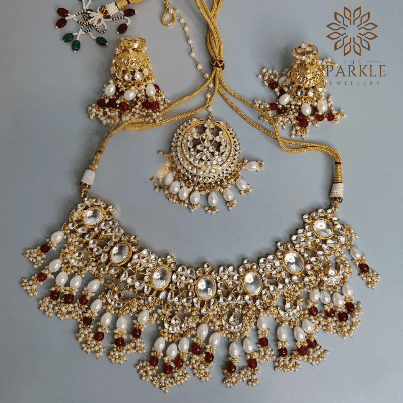 Pearl white and ruby red Jadau Pachi Kundan 22K gold plated necklace set with earrings and maangtikka by The Sparkle Jewellery