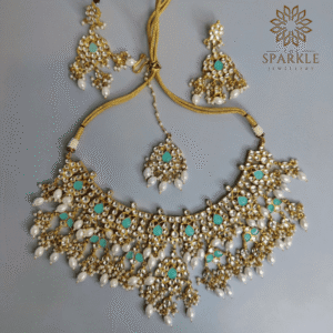 Mint green and pearl white Jadau Pachi Kundan 22K gold plated jewellery set with earrings and maangtikka by The Sparkle Jewellery