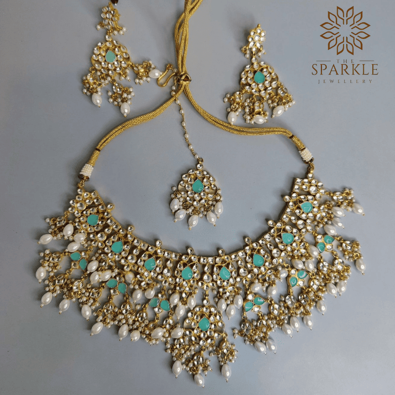 Mint green and pearl white Jadau Pachi Kundan 22K gold plated jewellery set with earrings and maangtikka by The Sparkle Jewellery