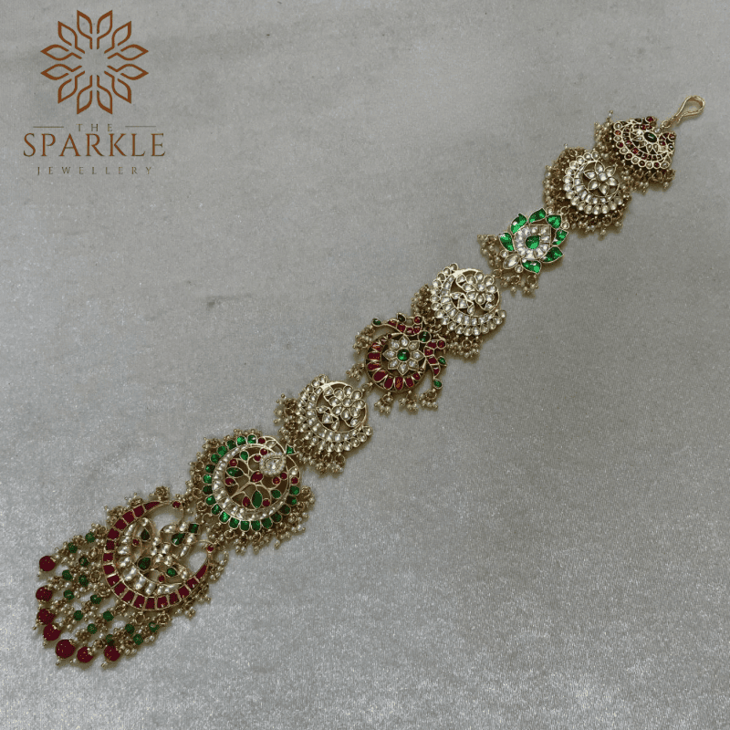jadau pachi kundan hair braid jewellery ruby red bead drops emerald green stones champagne white kundan pearl detailing 18k gold plated the sparkle jewellery