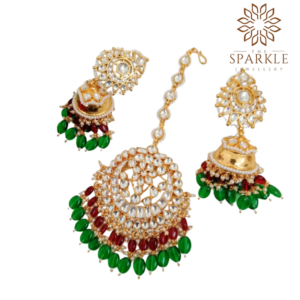 Green and red Pachi Kundan jhumka earrings with maangtikka set in 22K gold plated Jadau jewellery by The Sparkle Jewellery