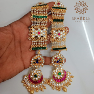 Long white Pachi Kundan jadau earrings with emerald green accents, rani pink crescent design, pearl layers and gold ghungroo drops in 22K gold plating by The Sparkle Jewellery