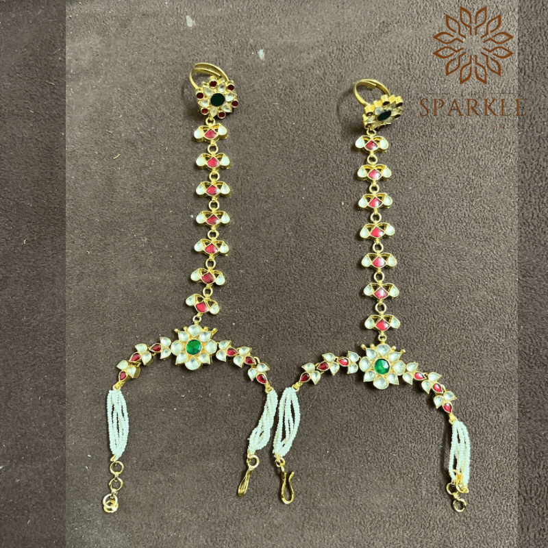 Off white ruby pink emerald green pachi jadau kundan hathphool hand harness with pearl bracelet chains 22k gold plated jewellery by The Sparkle Jewellery