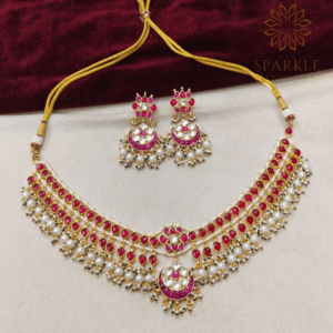 The Sparkle Jewellery ruby red jadau pachi kundan gold plated necklace set with pearl drops and matching earrings