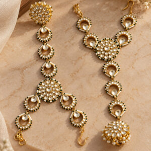 Green Kundan bridal hathphool with white stones, floral motifs, green bead accents, and gold-plated detailing.