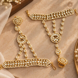 Gold-plated Kundan bridal hathphool with white stones, floral motifs, and pearl detailing.