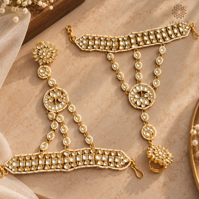 Gold-plated Kundan bridal hathphool with white stones, floral motifs, and pearl detailing.