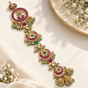 Jadau Kundan bridal hair braid with pink and green stones, pearl accents, and gold-plated detailing.